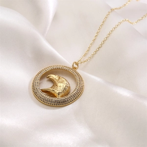 Detail of gold-plated eagle pendant with micro-pave crystals on white satin