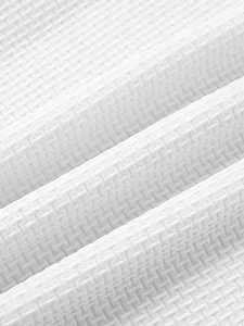 Macro shot of white waffle weave fabric texture showing high-quality breathable knit pattern