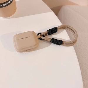 Detail of khaki silicone case for AirPods featuring a durable matching braided lanyard cord