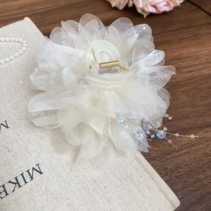 Detailed close-up of cream mesh flower hair claw clip with elegant pearl tassel charms