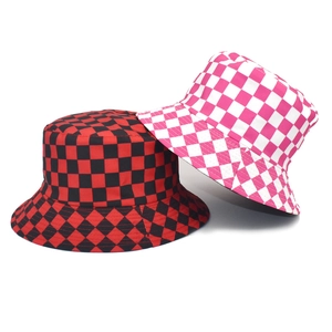 Detail view of red-black and pink-white checkered bucket hats with wide brims