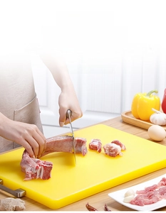 Thickened yellow PE cutting board with metal handle showing heavy duty meat chopping use