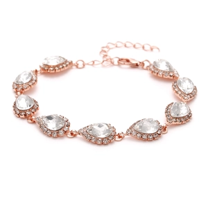 Close-up of rose gold bridal bracelet with pear-cut crystals and sparkling zircon border