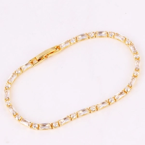 Detailed close-up of a gold-plated bracelet featuring vibrant rectangular cubic zirconia