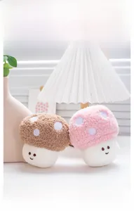 Close-up of cute mushroom plush pendants with embroidery faces in a cozy home setting