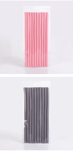 Detail view of pink and grey heatless foam hair rollers in transparent plastic packaging