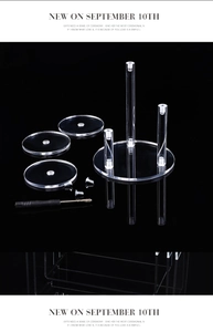 Exploded view of acrylic display stand components with round trays and mounting screws