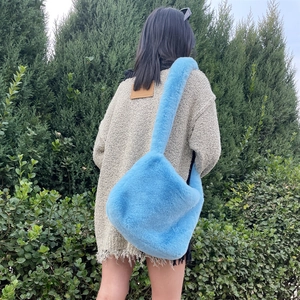 Close-up of bright blue faux fur tote bag showing soft texture and large shoulder design