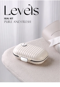 Detail view of mini portable cream-white pill box with textured stripes and metal lock