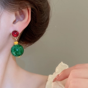 Detail view of vintage resin drop earrings with marble texture on ear of a model