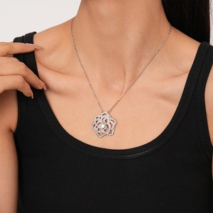 Detailed view of a silver-tone hollow rose pendant necklace encrusted with sparkling zircons