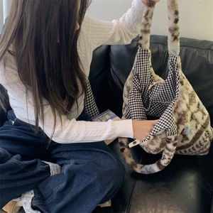Detail view of ethnic plush tote bag showing black and white checkered lining and soft texture