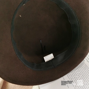 Detailed macro view of the 100% wool felt hat interior with black sweatband and label