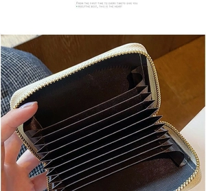 Detail view of the multi-slot accordion interior and zipper of the leather card holder