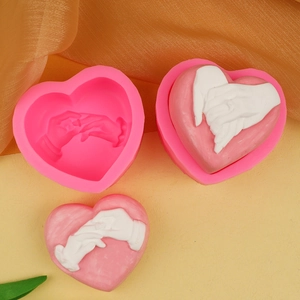 Detail of 3D heart hand-holding silicone mold and finished plaster resin art piece