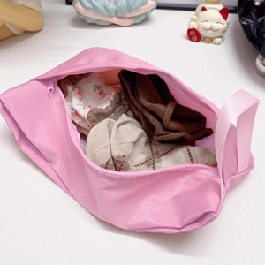 Pink waterproof travel organizer bag with handle for storing socks and undergarments