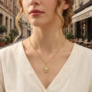 Retro filigree pendant necklace with center pearl in 18K gold plating worn by model