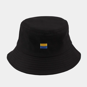 Classic black bucket hat featuring a small yellow and blue flag embroidery on front