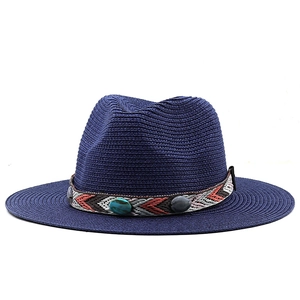 Détail du bandeau ethnique aux perles turquoise sur chapeau de paille bleu marine