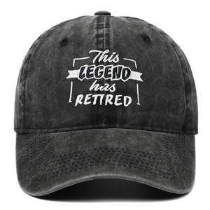 Washed black baseball cap with white This Legend Has Retired embroidery and curved brim