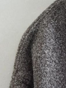 Macro texture view of grey curly fleece fabric on the casual high collar jacket