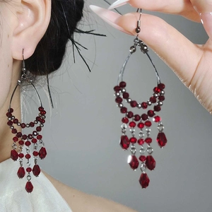 Bohemian silver drop earrings with faceted red glass beads and multilayered fringe tassels