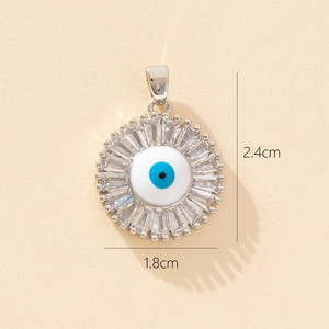 Detail view of evil eye sunburst pendant with dimensions 2.4cm by 1.8cm on beige background