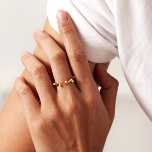 French vintage gold wave ring with white pearls on a model finger, elegant jewelry