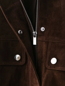 Close-up of deep brown suede jacket featuring metallic zippers and silver snap buttons
