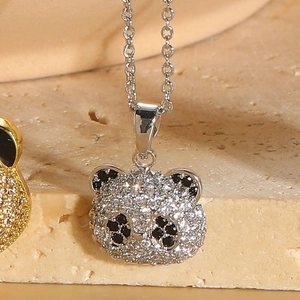 Macro shot of bear pendant necklace featuring pave-set black and white cubic zirconia
