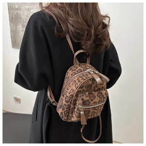 Rear view of a chic mini leopard print backpack styled for a casual feminine autumn look