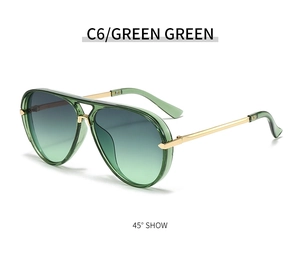 Detail of green aviator sunglasses with transparent resin frame and gold metal temples