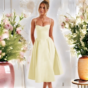 Détail d'une robe mi-longue jaune pâle dos nu avec fines bretelles et bustier corset