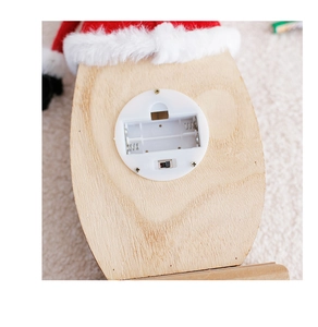 Close-up of wooden Santa decoration base with battery compartment and power switch