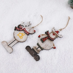 Wooden reindeer Christmas tree ornaments with natural jute rope on a white snow background