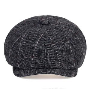 Dark grey herringbone newsboy cap with red windowpane pattern and classic peak brim