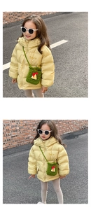 Toddler in yellow hooded puffer jacket with cute green crochet crossbody bag for winter