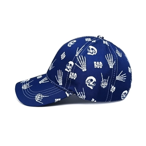 Detail of dark blue baseball cap with white skull, skeleton hands and BOO prints