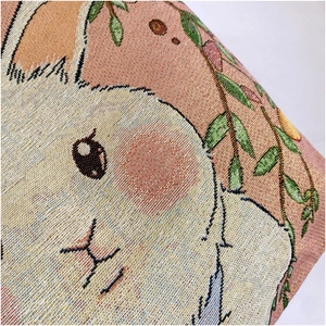 Close-up of intricate rabbit jacquard embroidery on woven canvas tote bag