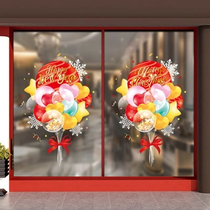 Detailed view of Merry Christmas and Happy New Year balloon stickers on a shop glass window