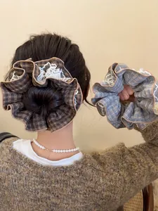 Close-up of oversized lace plaid scrunchies in dark and light blue checkered patterns