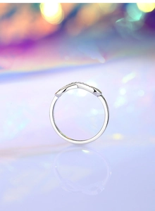 Macro detail of S925 sterling silver infinity ring with wavy lines and sparkling zircons