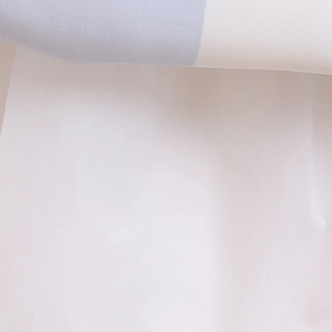 Detail of blue striped woven fabric with white breathable mesh lining for girl dress