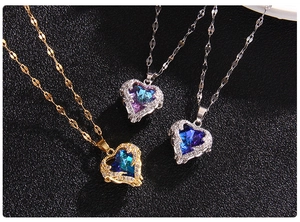 Detail of colorful heart crystal pendants with claw setting on elegant metal chains