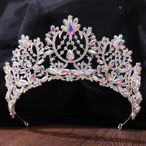 Close-up of baroque silver bridal tiara with colorful AB rhinestones on black fabric
