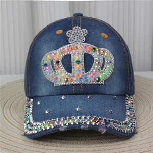 Detailed close-up of blue denim baseball cap with rhinestone crown and metal studs