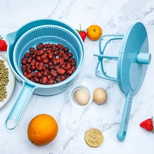 Light blue manual salad spinner and vegetable washer shown on a marble countertop