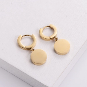 Minimalist gold plated Roman numeral hoop earrings with round pendant on white stone