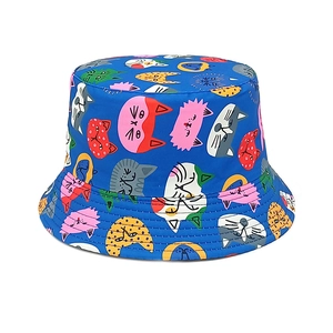 Close-up of royal blue fisherman hat with colorful cartoon cat prints and stitched brim
