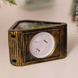 Macro detail of bronze vintage lantern base showing the battery compartment and power switch